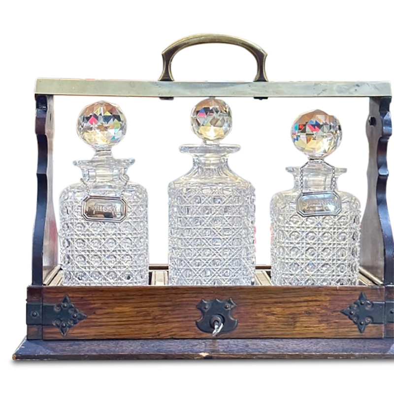 antique crystal whisky decanters set of 3 in an oak tantalus with a brass carry handle and lock