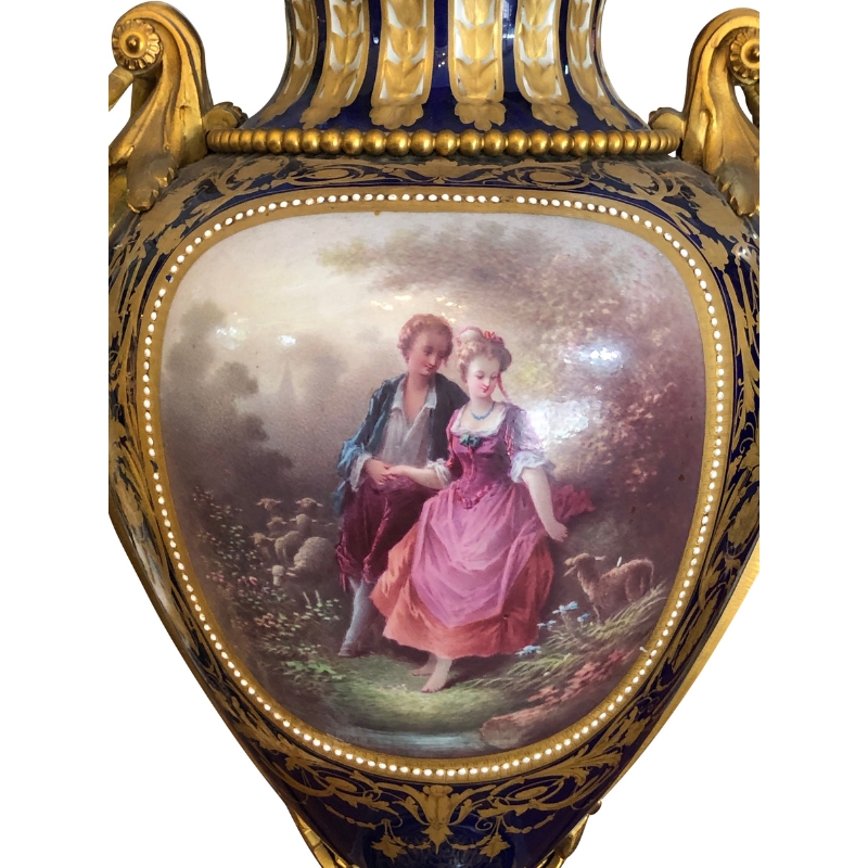 Hand painted detail of romantic courting scene on grand antique cobalt blue lidded sevres vases