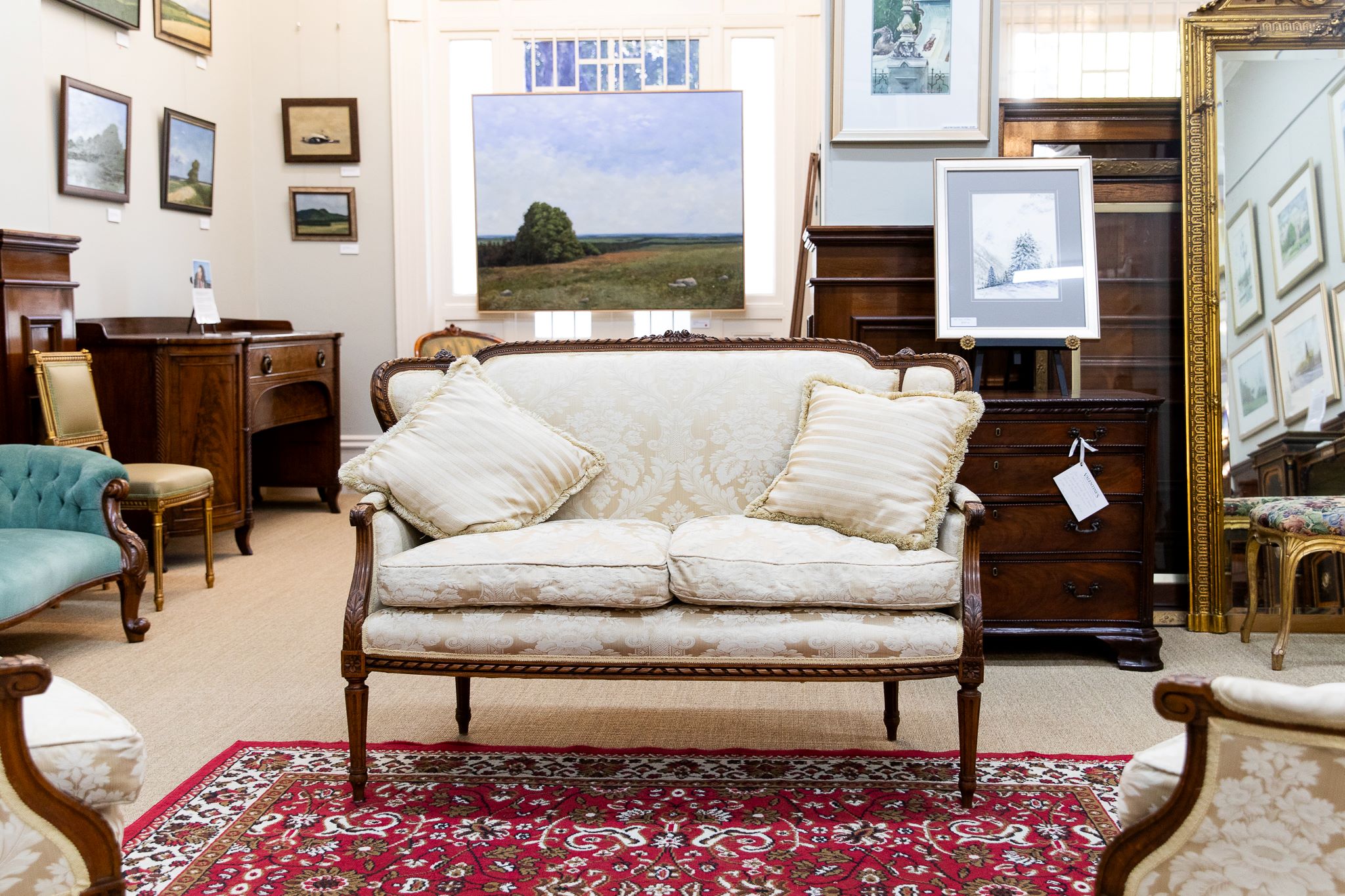 Heritage style gallery space with antique salon suite and artworks