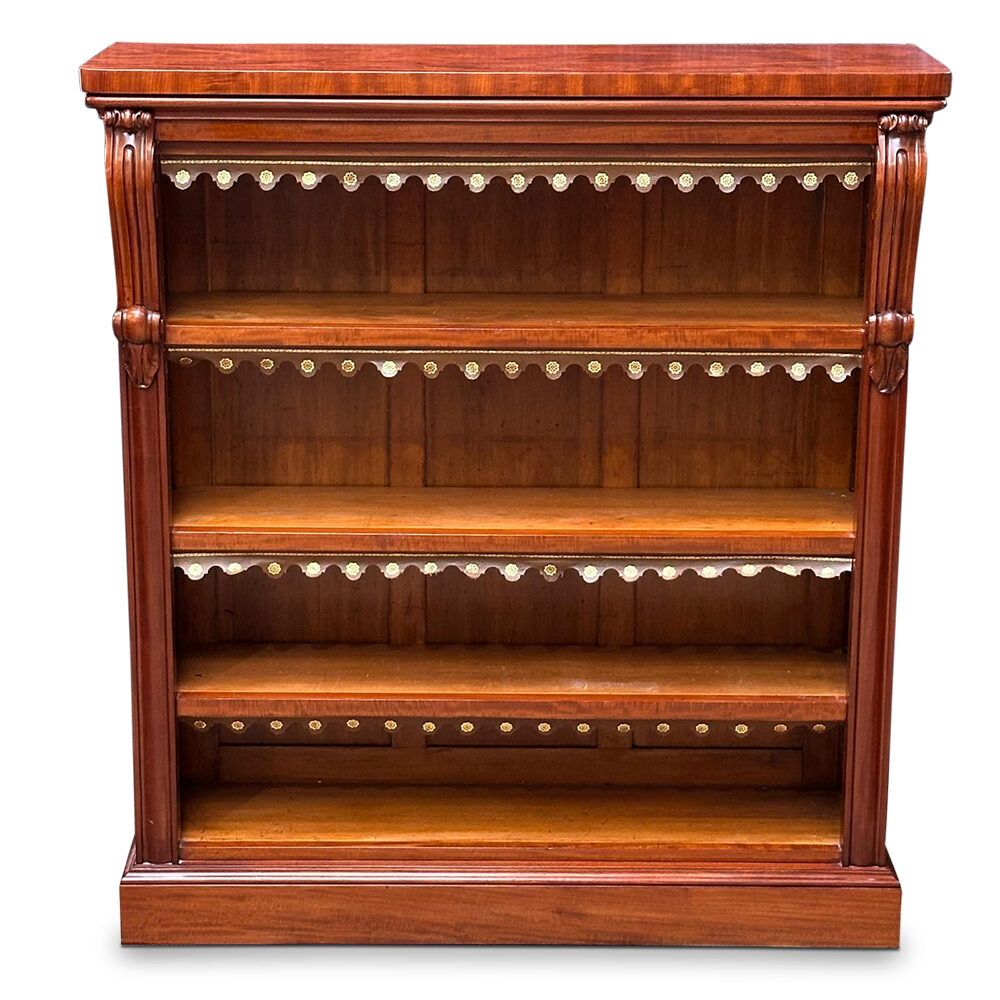 English mahogany open bookcase with carved corbels and tooled leather dust covers c.1850